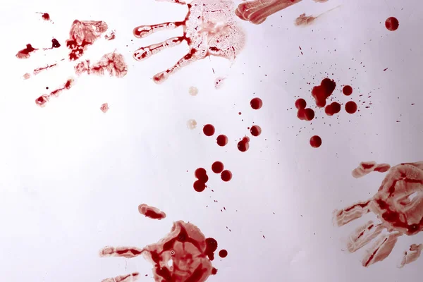 Red imprint of the bloody palm on a white background close up