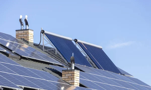 Solar installation for the generation of green electricity and water heating on the roof of a residential house close up