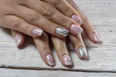 Manikür, izole bir beyaz ahşap arka plan üzerinde beyaz renk ile pembe yakın çekim