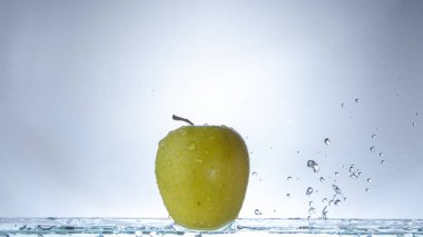 Açık renkli ve sıçramasına su yeşil elma yakın çekim
