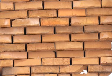 Ahşap palet kırmızı tuğla bir başka böyle palet üzerinde açık bir ambar kar kış güneşli bir günde kaplı.