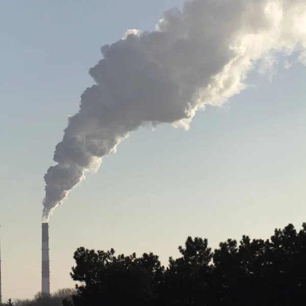 Pollution. Smoke from industrial chimneys against the blue sky