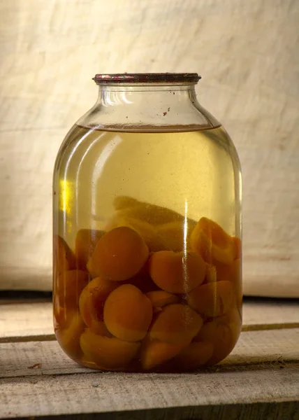 Bank of canned fruit compote on the shelf close up