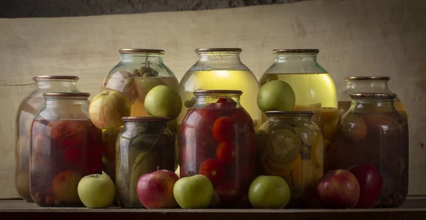 Home-made canned compote and fresh fruit on the basement shelf still life — Stock Photo, Image