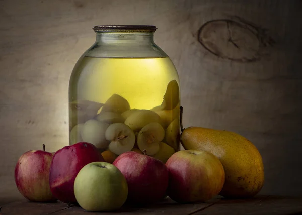 Home-made canned compote and fresh fruit on the basement shelf still life Royalty Free Stock Photos