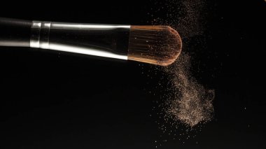 toz sıçrama ve fırça siyah arka planda makyaj sanatçısı veya güzellik blogcusu için