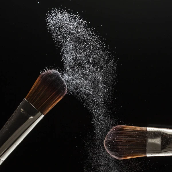 powder splash and brush for makeup artist or beauty blogger in black background
