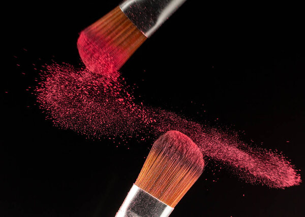 powder splash and brush for makeup artist or beauty blogger in black background