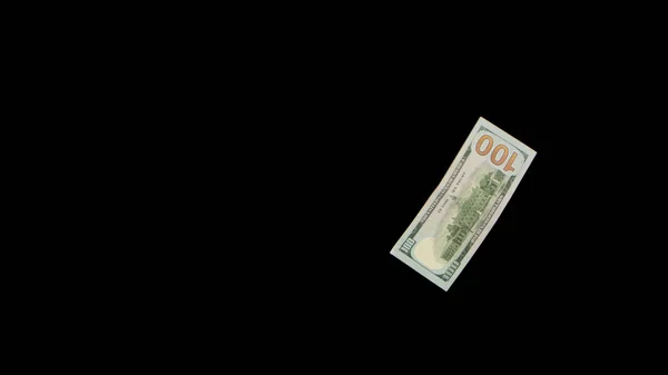 Létající dolary izolované na černém pozadí zblízka — Stock fotografie