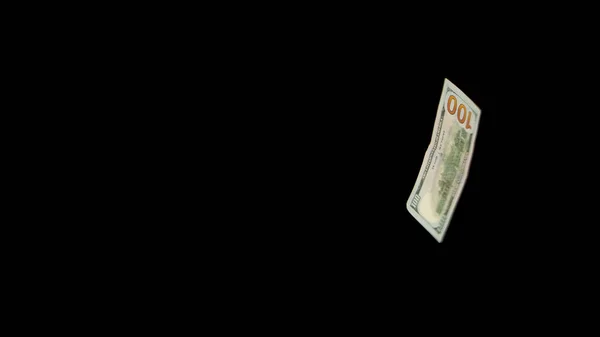 Flying dollars isolated on black background close-up — Stock Photo, Image