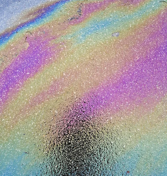 Multi colored oil spill on asphalt road, abstract background, — Stock Photo, Image