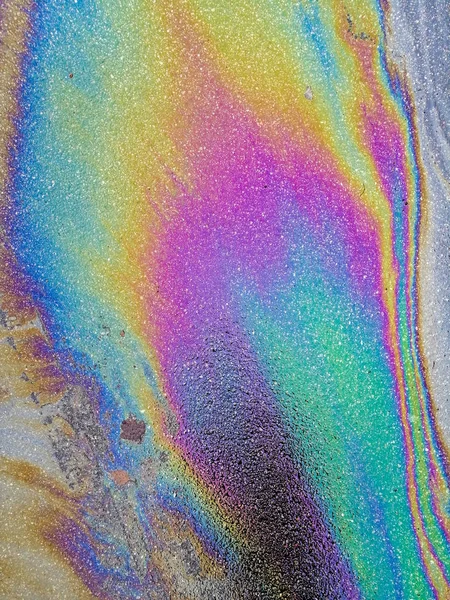 Multi colored oil spill on asphalt road, abstract background, — Stock Photo, Image