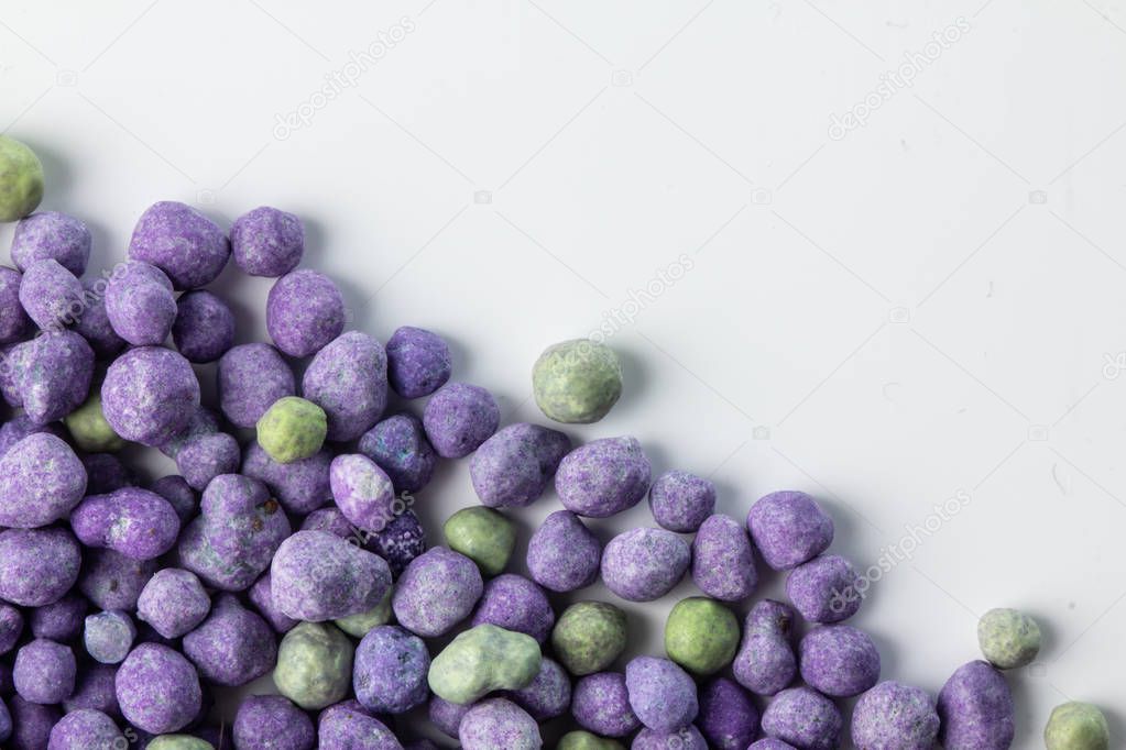 Purple mineral fertilizer, prolonged action with microelements, for application to the lawn in the spring. Professional fertilizer. On white background