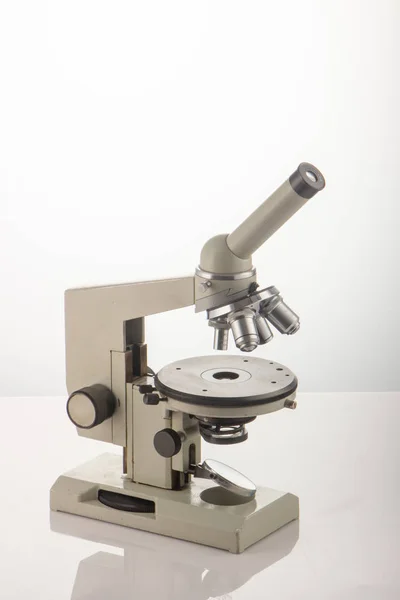 White microscope on table over white background close up — Stock Photo, Image