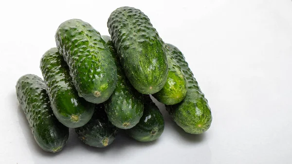 Beautiful young cucumbers on a white background — Stock Photo, Image