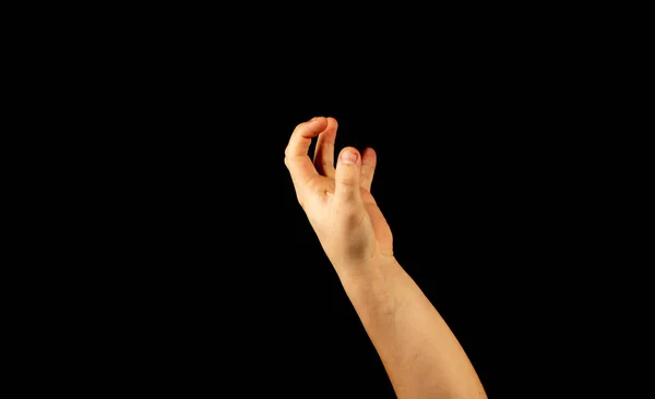 The hand of a young man on a black background — Stock Photo, Image