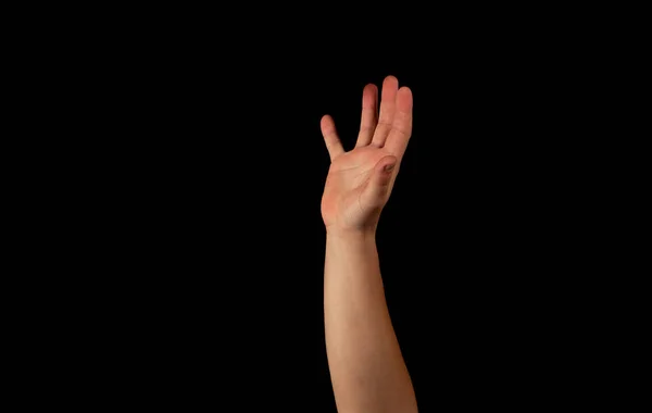 Die Hand eines jungen Mannes auf schwarzem Hintergrund — Stockfoto