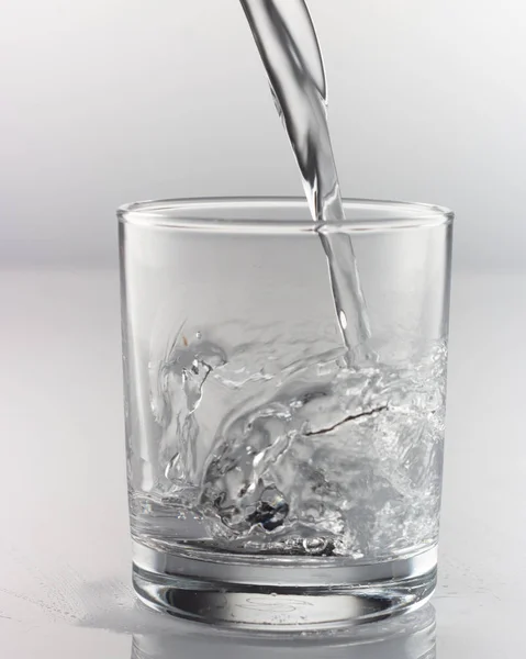 spray water in a glass on a gray background