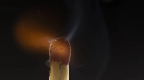 Burning wooden match with a red match head on a black background. — Stock Photo, Image