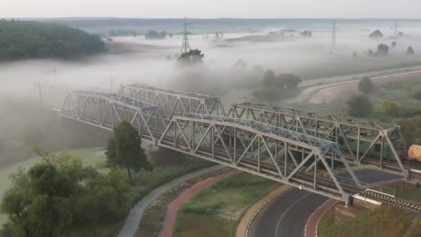 Ponte ferroviária de ferro ao amanhecer no nevoeiro — Vídeo de Stock