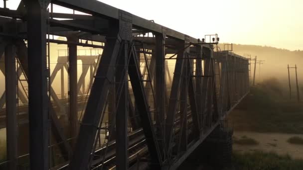 Iron railway bridge at dawn in the fog — Stock Video
