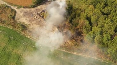 The garbage dump near the forest burns. Poor ecology, emissions into the atmosphere.