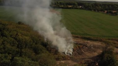 The garbage dump near the forest burns. Poor ecology, emissions into the atmosphere.
