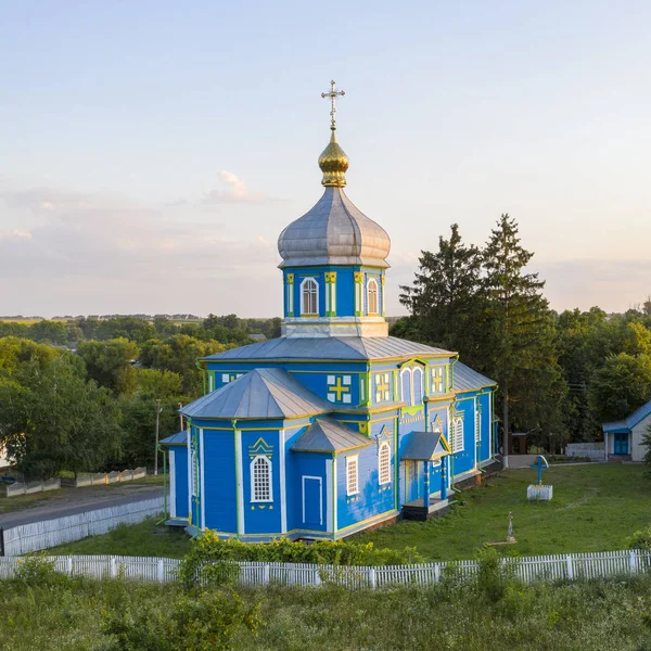 Old wooden church with metal roof. Located in a small village