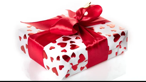 Gift box wrapped in white paper with red heart texture. And wrapped in a pink ribbon. — Stock Photo, Image