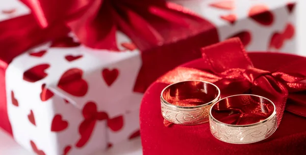 Two wedding rings in a red heart-shaped box — Stock Photo, Image