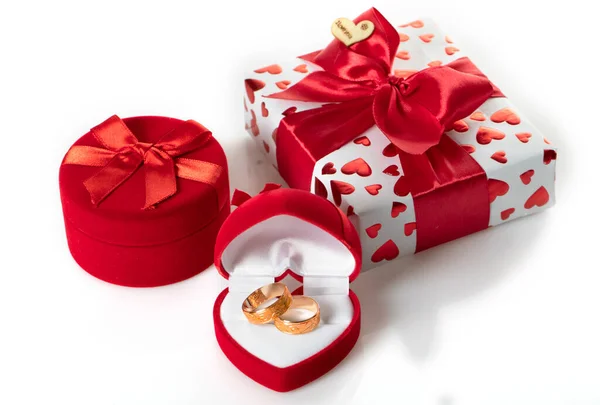 Two wedding rings in a red heart-shaped box — Stock Photo, Image