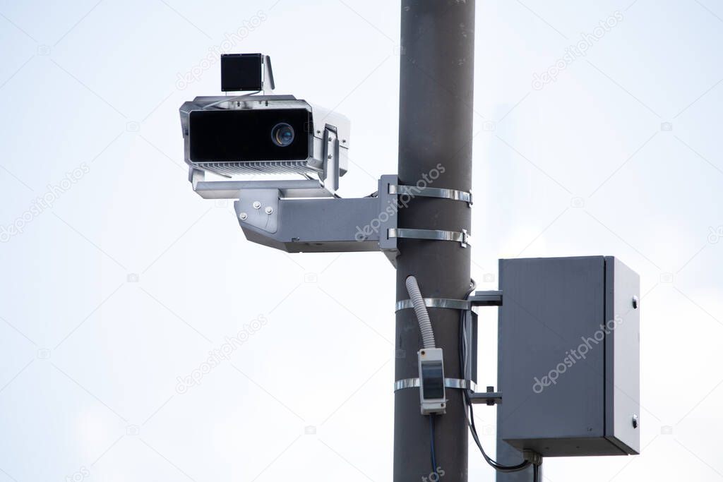 Stationary speed control camera on the support. Against the sky. Radars help ensure traffic safety and detect violators.