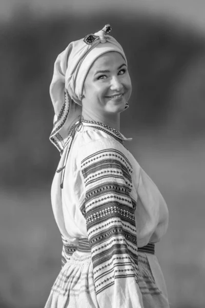 Young attractive woman in an embroidered linen shirt. Black and white — Stock Photo, Image