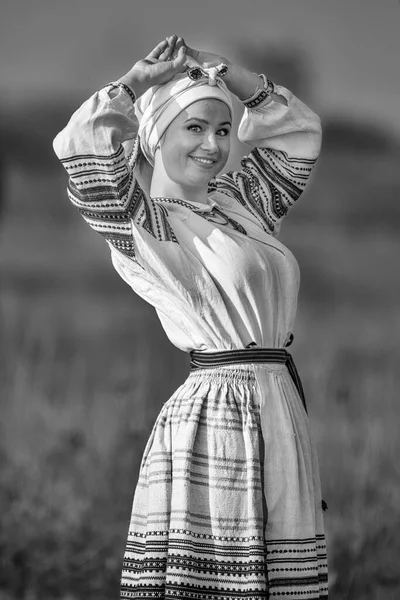 Young attractive woman in an embroidered linen shirt. Black and white — Stock Photo, Image