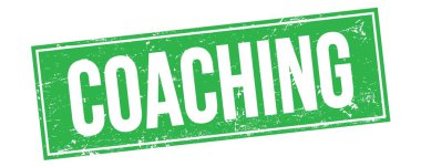 Yeşil grungy dikdörtgen mühür işareti üzerinde koçluk metni.