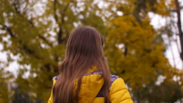 Mädchen mit langen Haaren spaziert durch Park — Stockvideo