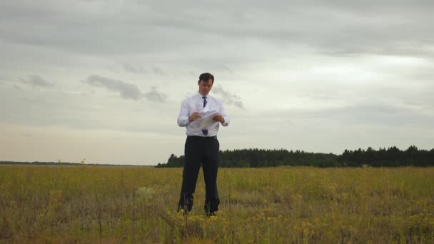 Hombre de negocios con camisa blanca y corbata azul arroja documentos al cielo . — Vídeos de Stock