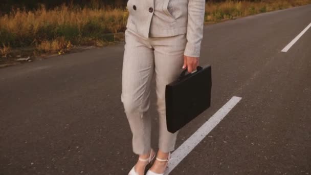 彼女の手で黒いブリーフケースのスーツのビジネスの女性は、仕事に行きます。クローズ アップ — ストック動画