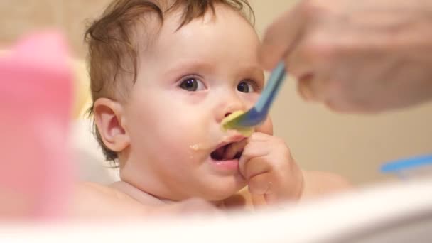 Mãe alimenta bebê de colher . — Vídeo de Stock