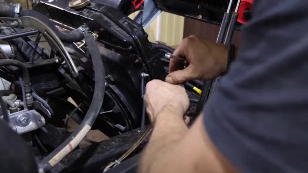 Car mechanic repairs car unscrews and tightens nut with the wrench — Stock Video