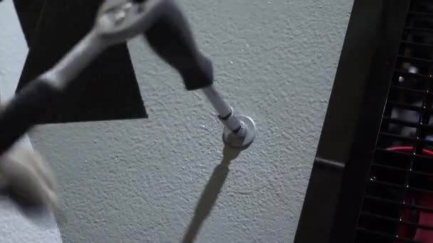 Locksmith spins bolt with a wrench, close-up — Stock Video