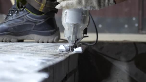 Sawing shiny sheet of metal with a jig saw. Close-up. — Stock Video