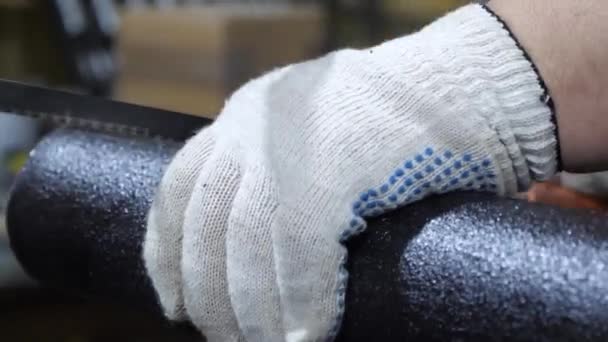 Serrurier dans des gants de protection scie tuyau noir avec une scie à métaux. homme travaille dans la manufacture. gros plan — Video