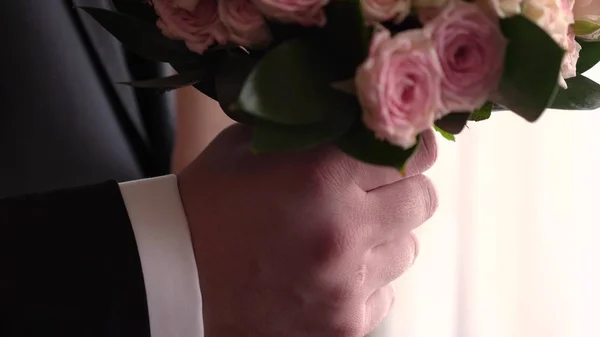 Beautiful bouquet of multicolored roses in the hands of men — Stock Photo, Image