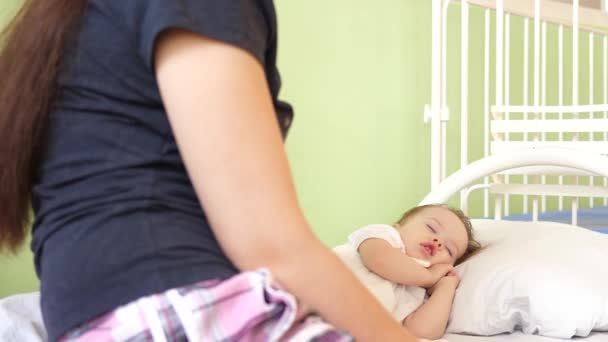Μαμά με μικρό μωρό στο νοσοκομείο ανάκτηση. Άρρωστο παιδί κοιμάται σε κρεβάτι white στο νοσοκομείο ward. Η μητέρα και το παιδί στο νοσοκομείο — Αρχείο Βίντεο