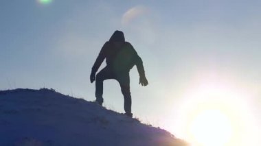 Adam dağcı düşmeyecek sırayla karlı dağ üzerinden yavaş yavaş iner. Aşırı zammı turist dağlarda. Gezgin zammı. Tepeler adam tarafından fethi