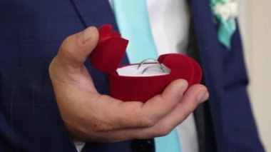 Damat düğün yüzük kutusuyla onun sevgili için teklifi için elinde tutar. Yeni aile oluşturma. Yakın çekim