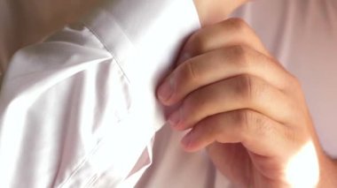 ofis çalışanı sabah giyinmiş. işadamı beyaz forması koyar. Erkekler bir düğme forması takılır. yakın çekim. adam iş için giyinmiş alır .