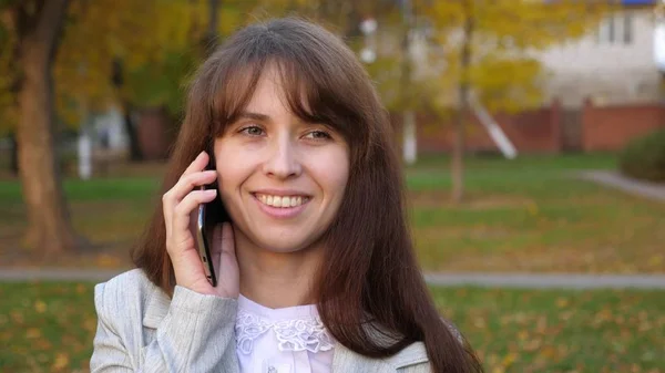 Mulher de negócios em terno de negócios falando no smartphone e sorrindo. A rapariga comunica por telefone. Close-up — Fotografia de Stock