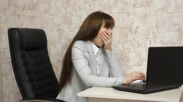 young business woman in her workplace. beautiful businesswoman woman in business correspondence on a laptop. young girl working in the office at the computer.